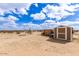 A well-maintained shed features desert landscaping with gravel and some foliage at 36989 S Riverbend Ln, Marana, AZ 85658