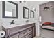Bathroom featuring dual sinks, framed mirrors, and a glimpse into an adjacent bedroom at 3925 W Hackamore Dr, Phoenix, AZ 85083