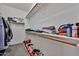 Walk-in closet with wooden racks, ample storage and rows of shoes at 3925 W Hackamore Dr, Phoenix, AZ 85083