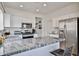 Modern kitchen featuring white cabinets, stainless steel appliances, and sleek granite countertops at 3925 W Hackamore Dr, Phoenix, AZ 85083