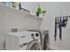 Laundry room featuring modern washer and dryer units with shelving and decor at 3925 W Hackamore Dr, Phoenix, AZ 85083
