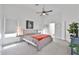 Bright main bedroom features a ceiling fan, neutral carpet, and a comfortable queen-size bed at 3925 W Hackamore Dr, Phoenix, AZ 85083
