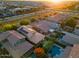 Aerial view of rooftops and swimming pools in a suburban neighborhood at sunset at 4084 E Rawhide St, Gilbert, AZ 85296