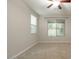 Neutral bedroom with carpeted floors, two windows, and a ceiling fan at 4084 E Rawhide St, Gilbert, AZ 85296