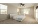 Well-lit bedroom with large windows, ceiling fan, and a stylish bed with crib at 4084 E Rawhide St, Gilbert, AZ 85296
