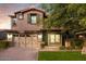 Charming two-story home featuring a paved driveway and a well-manicured lawn at 4084 E Rawhide St, Gilbert, AZ 85296