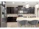 Spacious kitchen featuring dark cabinets, stainless appliances, and a large island at 4084 E Rawhide St, Gilbert, AZ 85296