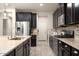 Beautiful kitchen featuring dark cabinets, a stainless steel fridge, granite countertops, and tile backsplash at 4084 E Rawhide St, Gilbert, AZ 85296