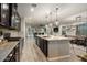 Spacious kitchen featuring dark cabinets, stainless appliances, and a large island at 4084 E Rawhide St, Gilbert, AZ 85296