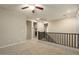 Spacious carpeted loft with neutral walls, a ceiling fan, recessed lighting, and iron railing at 4084 E Rawhide St, Gilbert, AZ 85296