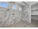 Luxurious bathroom with marble shower, glass enclosure, and walk-in closet access at 4211 E Desert Vista Trl, Cave Creek, AZ 85331