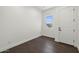 Minimalist bedroom with dark wood floors, a window, and a door at 4211 E Desert Vista Trl, Cave Creek, AZ 85331