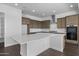 This kitchen features an island, modern appliances, wood floors, and a stainless steel hood at 4211 E Desert Vista Trl, Cave Creek, AZ 85331