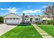 Charming white home with a lush green lawn and inviting walkway to the front door at 4507 E Weldon Ave, Phoenix, AZ 85018