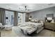 Relaxing bedroom featuring a stylish light fixture and french doors leading to the living room at 4507 E Weldon Ave, Phoenix, AZ 85018