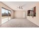 Bright living room with sliding glass doors to the backyard, ceiling fan and bar to kitchen at 4533 S Terrace Rd, Tempe, AZ 85282