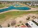 Aerial view showcases a well-maintained golf course community with scenic lakes and green fairways at 4538 E Shomi St, Phoenix, AZ 85044