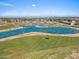 Scenic aerial view of a golf course community with lush greenery and a beautiful blue pond at 4538 E Shomi St, Phoenix, AZ 85044