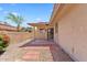 Backyard patio with desert landscaping, a covered area, and a rear entry door at 4538 E Shomi St, Phoenix, AZ 85044