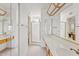 Spacious bathroom featuring a double vanity, multiple mirrors, and a separate shower stall at 4538 E Shomi St, Phoenix, AZ 85044