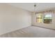 Bedroom features a ceiling fan and a window with views of the desert landscape at 4538 E Shomi St, Phoenix, AZ 85044