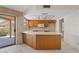 Cozy kitchen with white countertops, wooden cabinets, and a sliding door leading to the patio at 4538 E Shomi St, Phoenix, AZ 85044