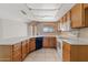 Functional kitchen with a wrap-around countertop, and white appliances, and tile floors at 4538 E Shomi St, Phoenix, AZ 85044