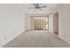 Bright living room with a ceiling fan and sliding glass door to the patio at 4538 E Shomi St, Phoenix, AZ 85044