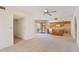 Bright living room showcasing an open floor plan, neutral carpet, and easy kitchen access to outdoor patio at 4538 E Shomi St, Phoenix, AZ 85044