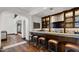Basement bar area featuring a stylish backsplash, display shelving, and comfortable seating at 4743 N 54Th St, Phoenix, AZ 85018