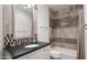 Cozy bathroom with a combination shower and tub, vanity, and decorative mirror at 4743 N 54Th St, Phoenix, AZ 85018