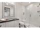 Elegant bathroom featuring a glass shower, black and white tile, and framed mirror at 4743 N 54Th St, Phoenix, AZ 85018