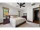Comfortable bedroom with a ceiling fan, dresser, and windows with decorative coverings at 4743 N 54Th St, Phoenix, AZ 85018