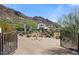 Gated entrance to a luxurious home with well-maintained landscaping and mountain views at 4743 N 54Th St, Phoenix, AZ 85018