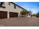Exterior view of a multi-car garage with brick driveway and mature tree at 4743 N 54Th St, Phoenix, AZ 85018