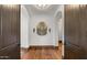 Inviting hallway showcasing hardwood floors, arched doorways, and decorative mirror at 4743 N 54Th St, Phoenix, AZ 85018