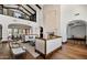 Elegant living room boasts tall ceilings, fireplace, and balcony with sophisticated furnishings at 4743 N 54Th St, Phoenix, AZ 85018