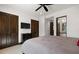 Stylish main bedroom featuring a ceiling fan, wall-mounted TV, and access to a bathroom at 4743 N 54Th St, Phoenix, AZ 85018