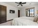 Bright main bedroom with a ceiling fan, mounted TV, and large window with a view at 4743 N 54Th St, Phoenix, AZ 85018