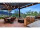 Outdoor kitchen with built-in grill, dining area, and beautiful backyard views at 4743 N 54Th St, Phoenix, AZ 85018