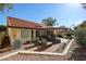 Beautiful backyard featuring a covered patio, seating area, and lush landscaping at 5055 E Paseo Way, Phoenix, AZ 85044