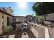 Well-maintained backyard featuring a covered patio, outdoor seating, and beautifully landscaped gardens at 5055 E Paseo Way, Phoenix, AZ 85044