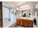 Bathroom with a soaking tub, double sinks, and tile flooring with a view into the bedroom at 5055 E Paseo Way, Phoenix, AZ 85044