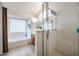 Bright bathroom featuring a soaking tub and separate shower with clear glass door at 5055 E Paseo Way, Phoenix, AZ 85044