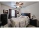 Well-lit bedroom featuring a large bed, a ceiling fan, and tile floors at 5055 E Paseo Way, Phoenix, AZ 85044