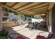 Inviting covered patio featuring ceiling fan and well-maintained landscaping for relaxing outdoor experience at 5055 E Paseo Way, Phoenix, AZ 85044