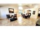 Open-concept dining room featuring tile flooring, a high ceiling, and elegant dark wood furniture at 5055 E Paseo Way, Phoenix, AZ 85044