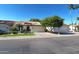 Single-story home with tiled roof, mature landscaping, and an attached two-car garage situated in a desirable community at 5055 E Paseo Way, Phoenix, AZ 85044