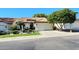 Charming single-story home with a tile roof, lush landscaping, and attached garage, ready for move-in at 5055 E Paseo Way, Phoenix, AZ 85044