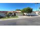 Inviting single-story home boasting a red tile roof, mature tree in the front yard, and an attached two-car garage at 5055 E Paseo Way, Phoenix, AZ 85044